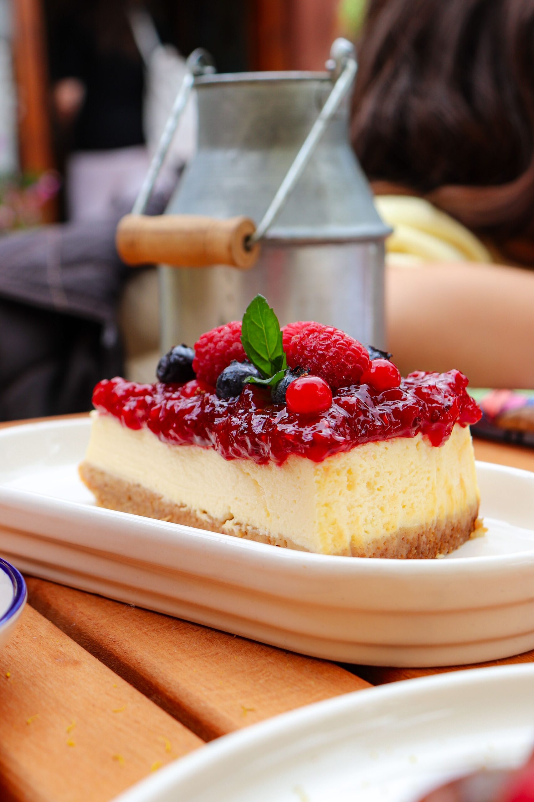 Close-up of a creamy cheesecake topped with mixed berries, perfect for a summer dessert.